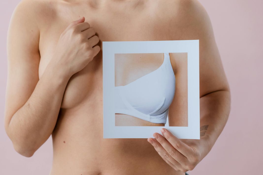 Lady holding bra photograph for Cancer support