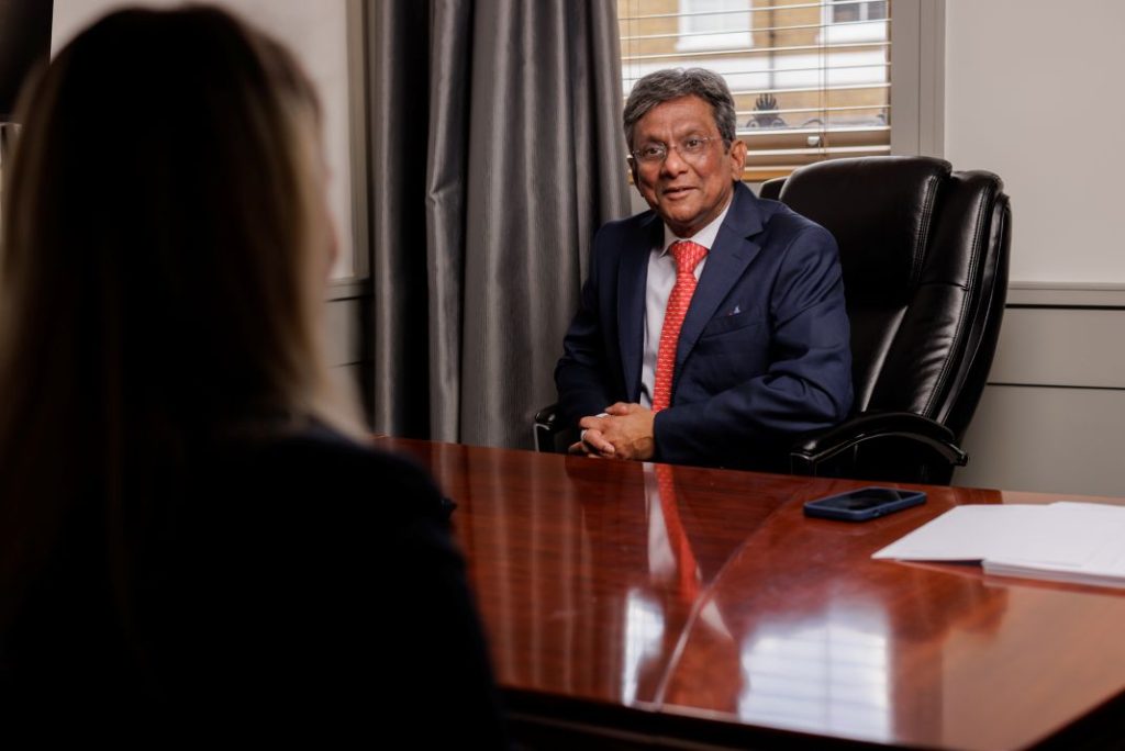 DB Ghosh at desk during consultation