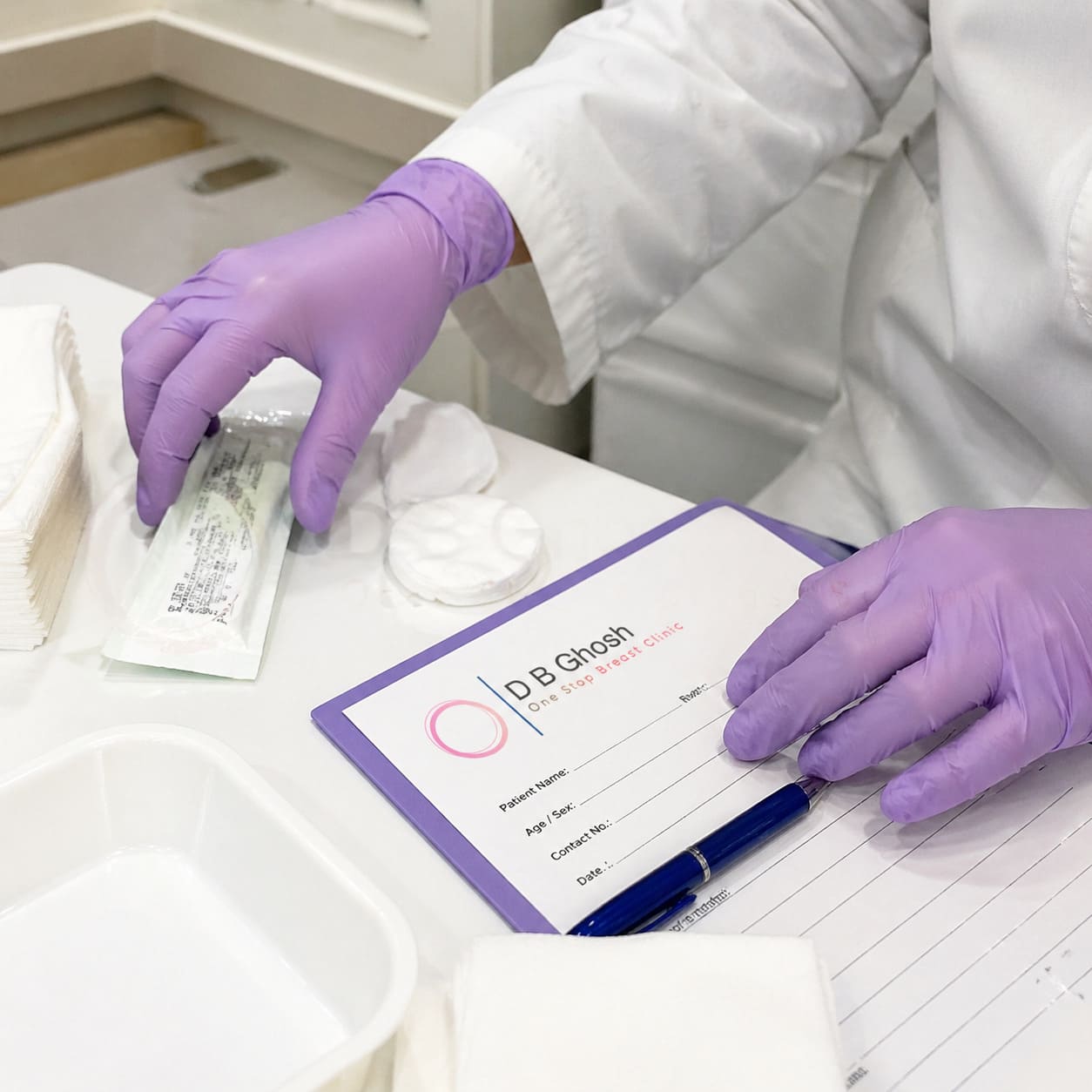 Breast Clinic Administration – Gloved Hands Preparing Patient Documents